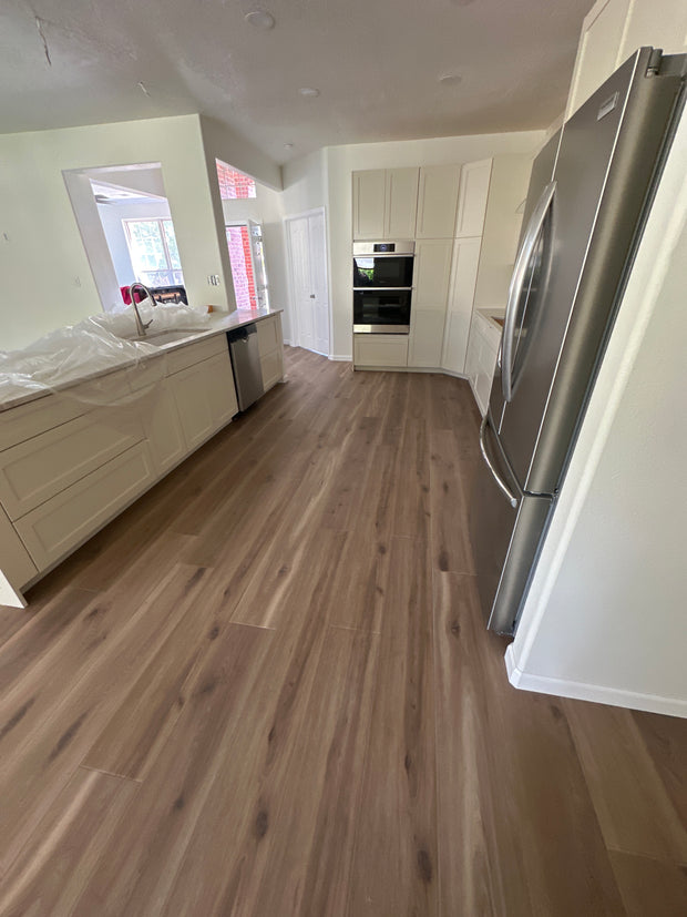 Modern kitchen interior with wooden wall and white cabinetry