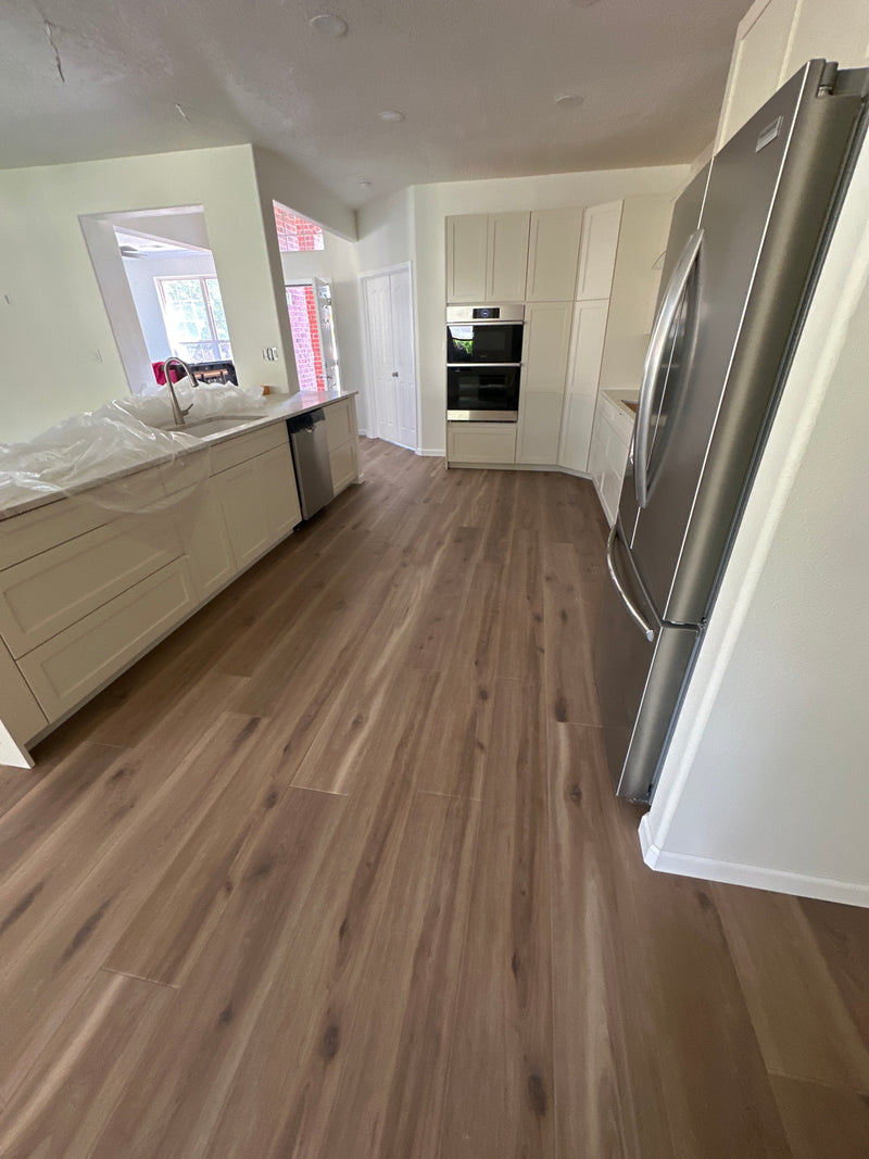 Modern kitchen interior with wooden wall and white cabinetry