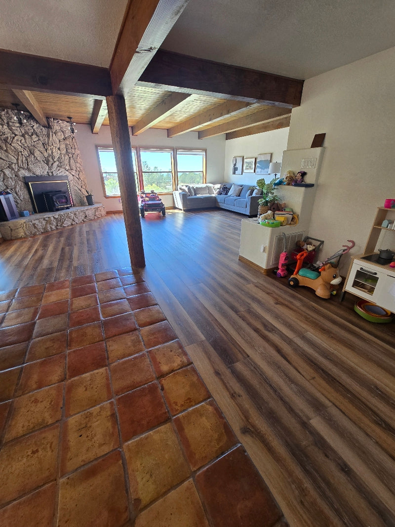 Staircase leading down to a living room with a tiled floor.