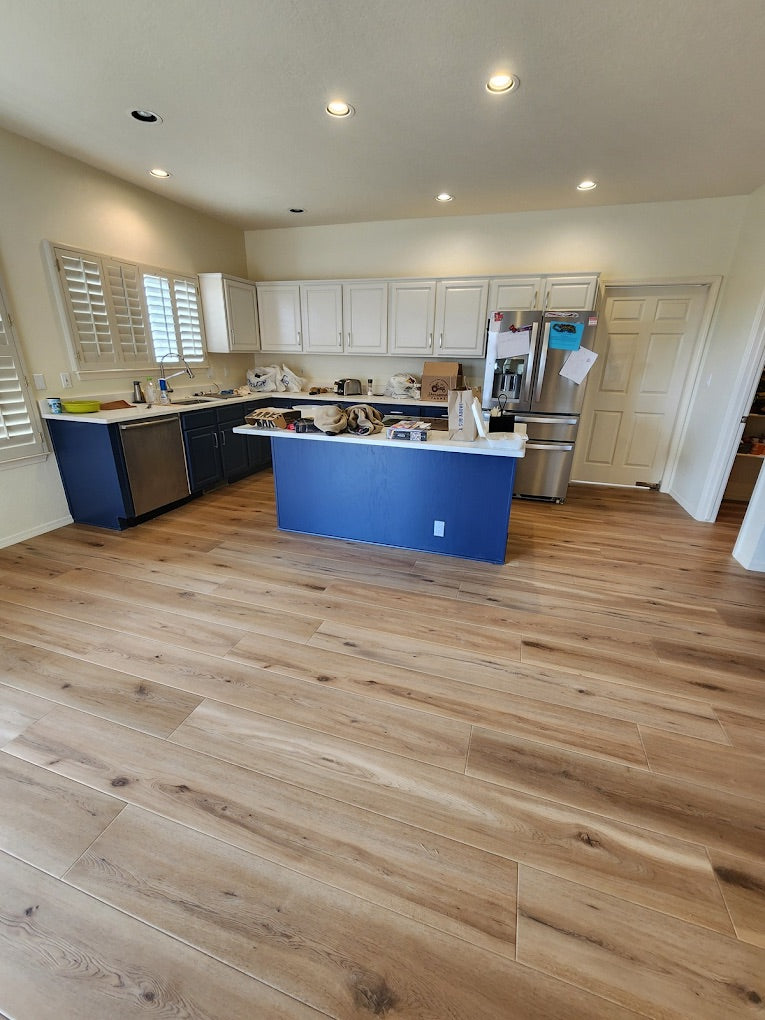 Modern kitchen with wooden flooring and white cabinets