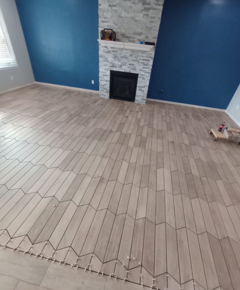 Room with tile herringbone flooring and blue walls